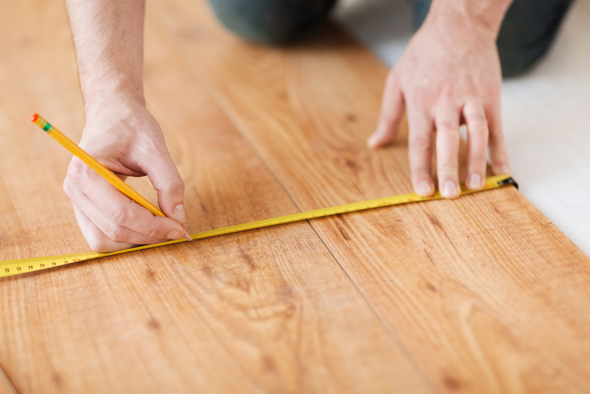 contractor measuring laminate flooring  